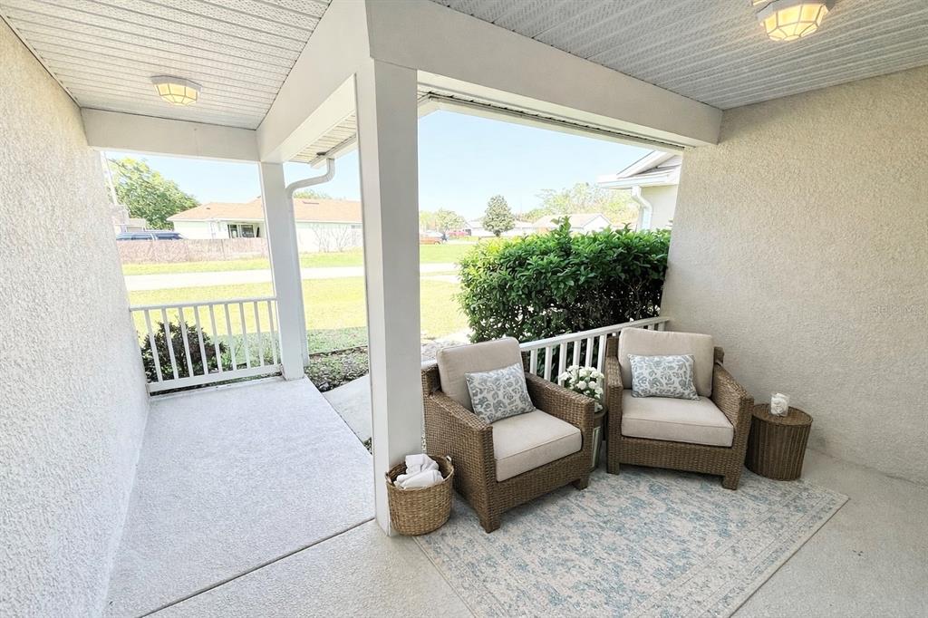 1220 Myrtle Avenue St. Cloud, FL 34771 - Photo 22 of 59 a living room with furniture and a floor to ceiling window