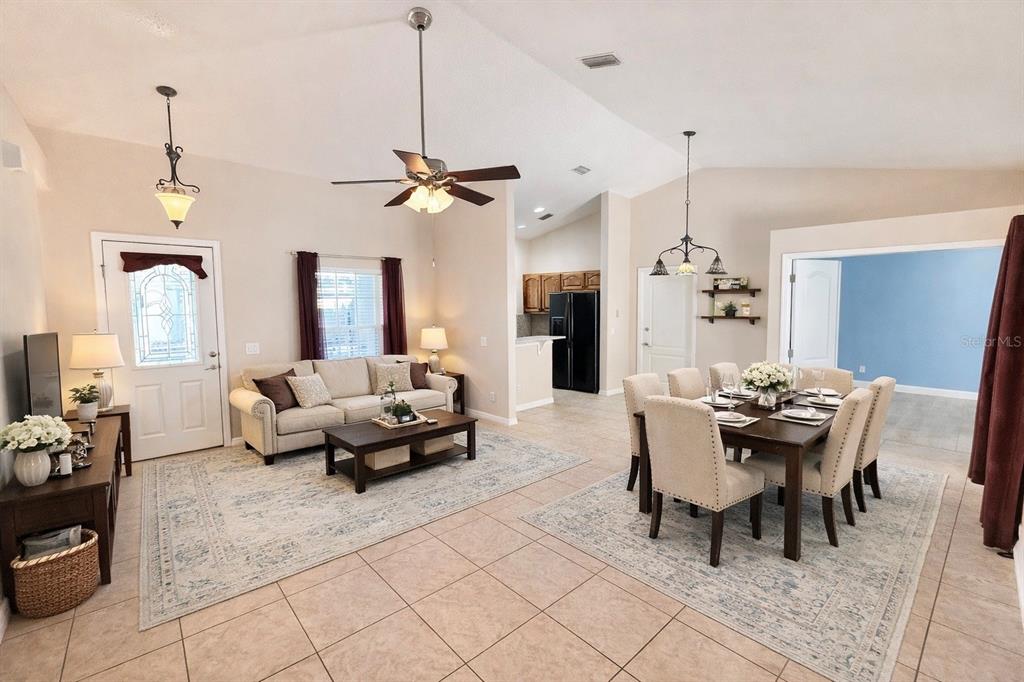 1220 Myrtle Avenue St. Cloud, FL 34771 - Photo 28 of 59 a living room with furniture a window and a chandelier