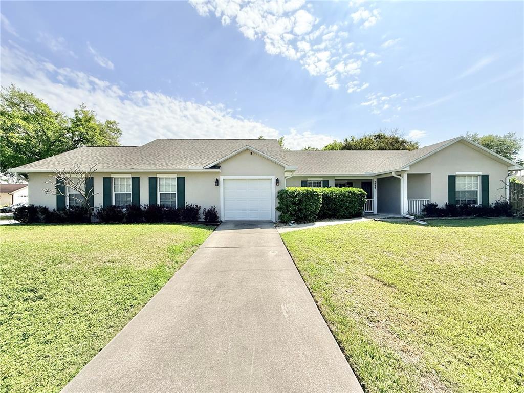 1220 Myrtle Avenue St. Cloud, FL 34771 - Photo 3 of 59 a front view of a house with a garden and yard