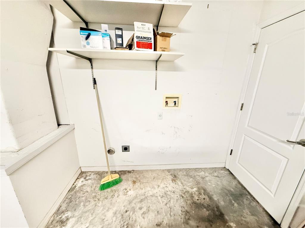 1220 Myrtle Avenue St. Cloud, FL 34771 - Photo 32 of 59 a view of storage and utility room with washer and dryer