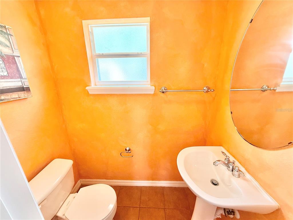 1220 Myrtle Avenue St. Cloud, FL 34771 - Photo 37 of 59 a bathroom with a sink mirror and toilet
