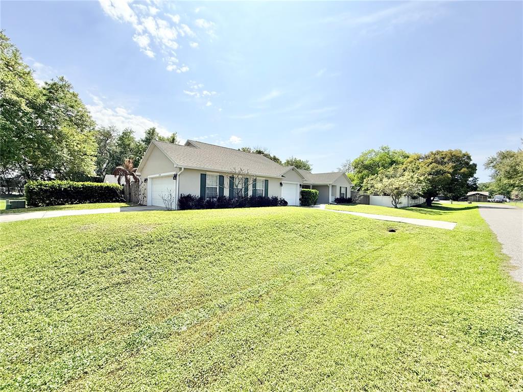1220 Myrtle Avenue St. Cloud, FL 34771 - Photo 47 of 59 a view of a house with a big yard and large trees