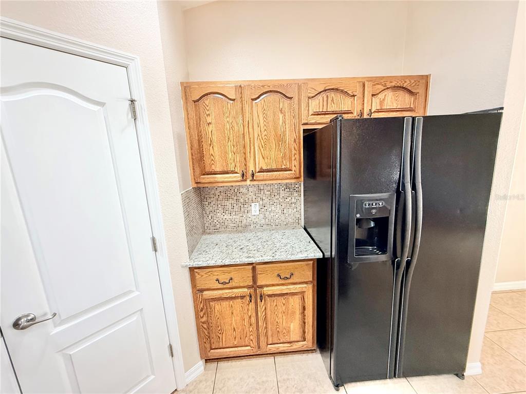 1220 Myrtle Avenue St. Cloud, FL 34771 - Photo 5 of 59 a bathroom with a granite countertop shower a mirror and a sink