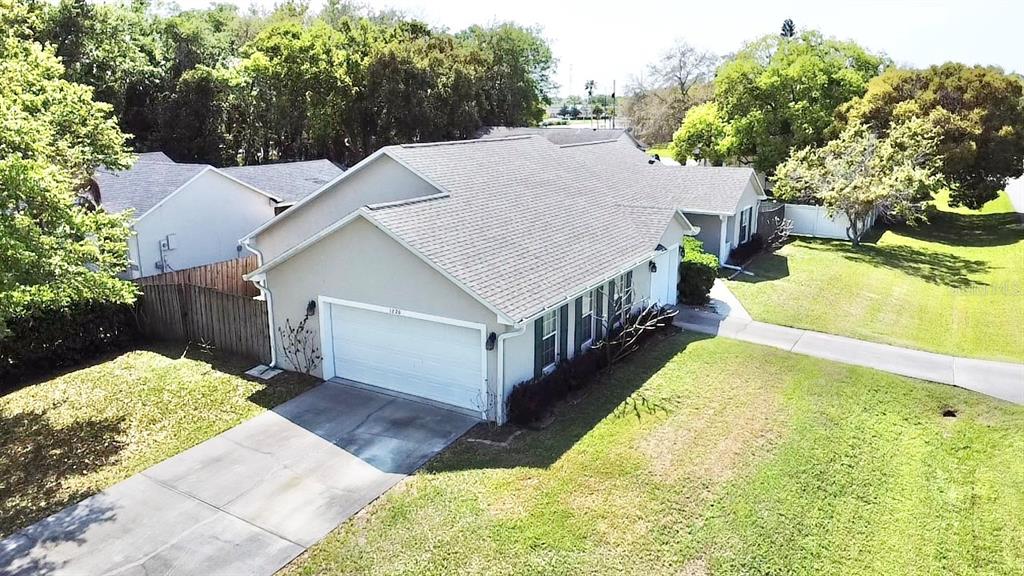 1220 Myrtle Avenue St. Cloud, FL 34771 - Photo 53 of 59 a view of a house with a yard and lawn chairs