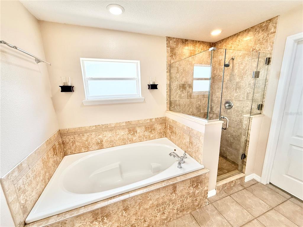 1220 Myrtle Avenue St. Cloud, FL 34771 - Photo 9 of 59 a bathroom with a bathtub and a shower