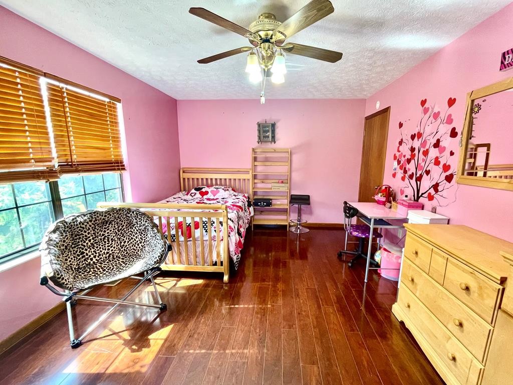 1050 Powder Springs Road Sevierville, TN 37876 - Photo 14 of 33 a bedroom with furniture and a wooden floor