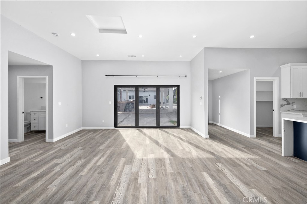 19613 Lanark Street, Unit 1/4 Reseda, CA 91335 - Photo 14 of 38 a view of an empty room with a fireplace and a window