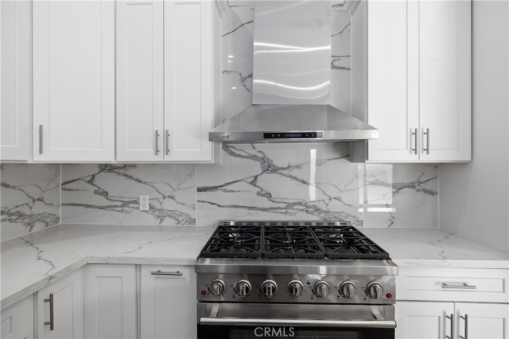 19613 Lanark Street, Unit 1/4 Reseda, CA 91335 - Photo 16 of 38 a stove top oven sitting inside of a kitchen