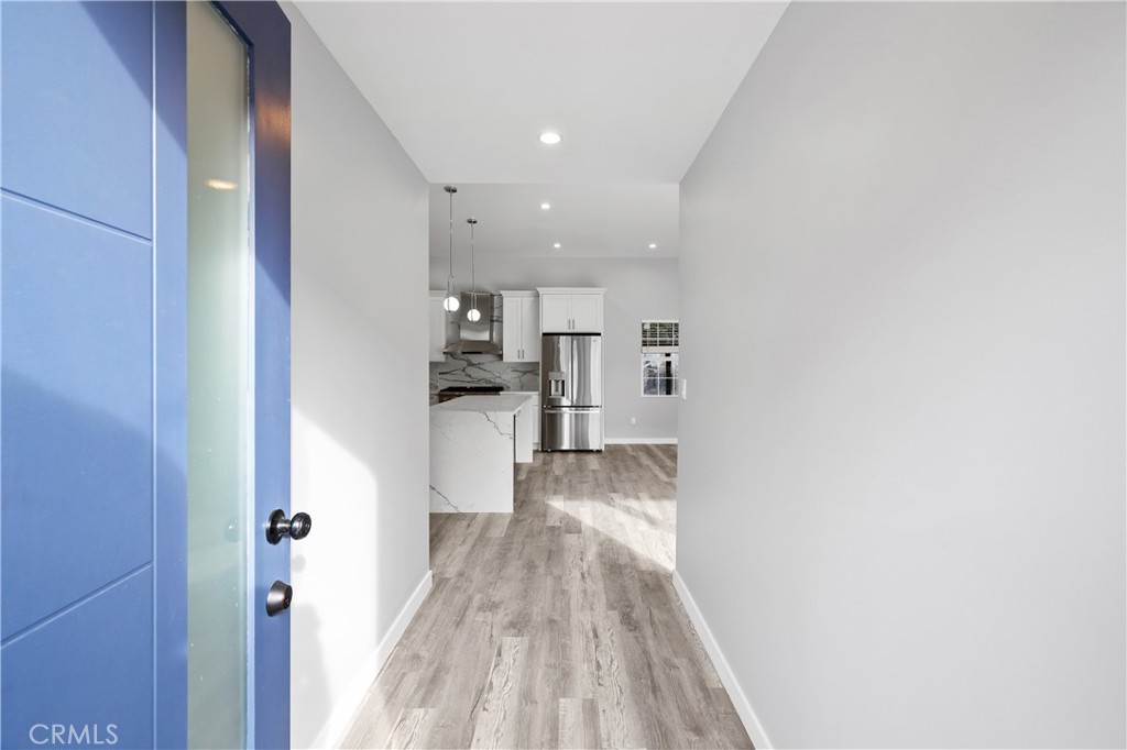 19613 Lanark Street, Unit 1/4 Reseda, CA 91335 - Photo 2 of 38 a view of a kitchen from the hallway