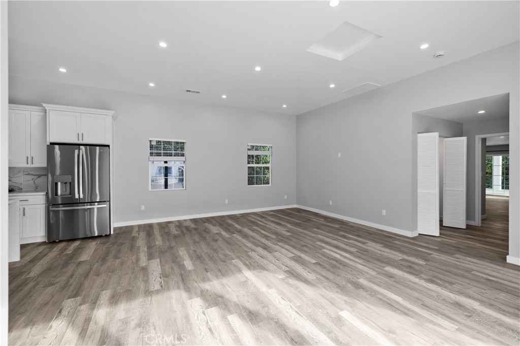 19613 Lanark Street, Unit 1/4 Reseda, CA 91335 - Photo 22 of 38 a view of empty room with wooden floor and electronic appliances