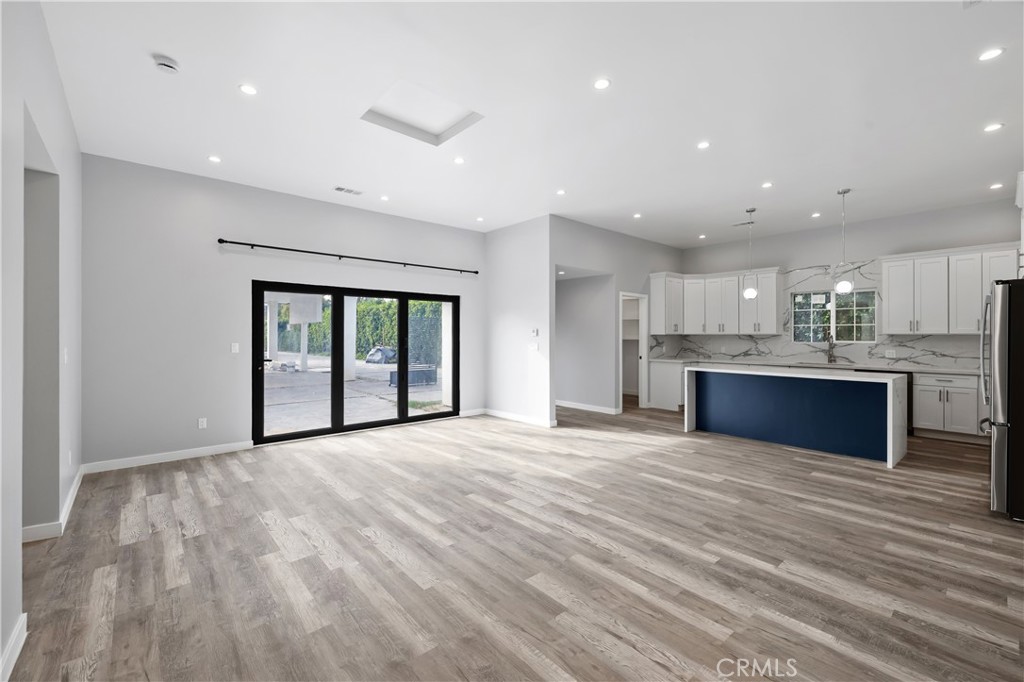 19613 Lanark Street, Unit 1/4 Reseda, CA 91335 - Photo 24 of 38 a view of kitchen with kitchen island sink and wooden floor