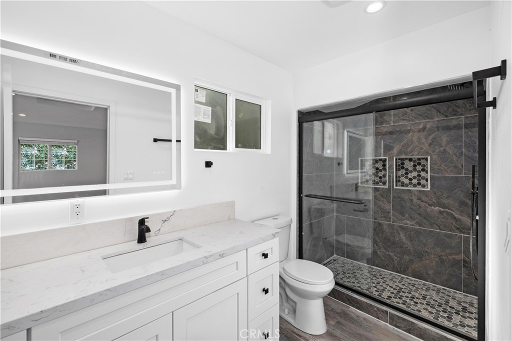 19613 Lanark Street, Unit 1/4 Reseda, CA 91335 - Photo 7 of 38 a bathroom with a sink a toilet and shower