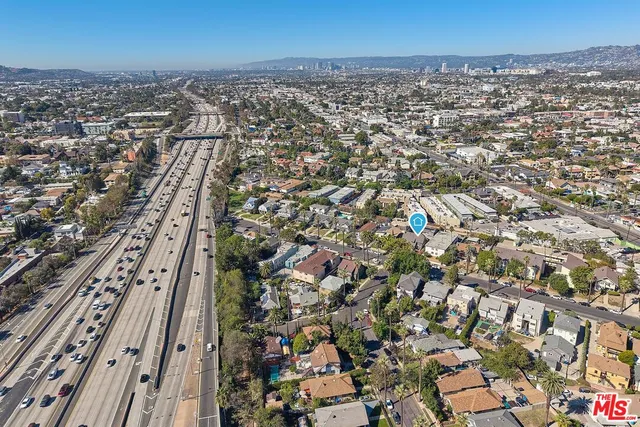 a view of a living room with wooden floor and furniture
