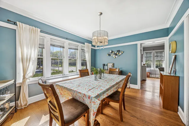 a view of a dining room with furniture wooden floor and chandelier