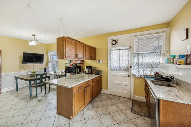 a kitchen with a stove a sink and a refrigerator