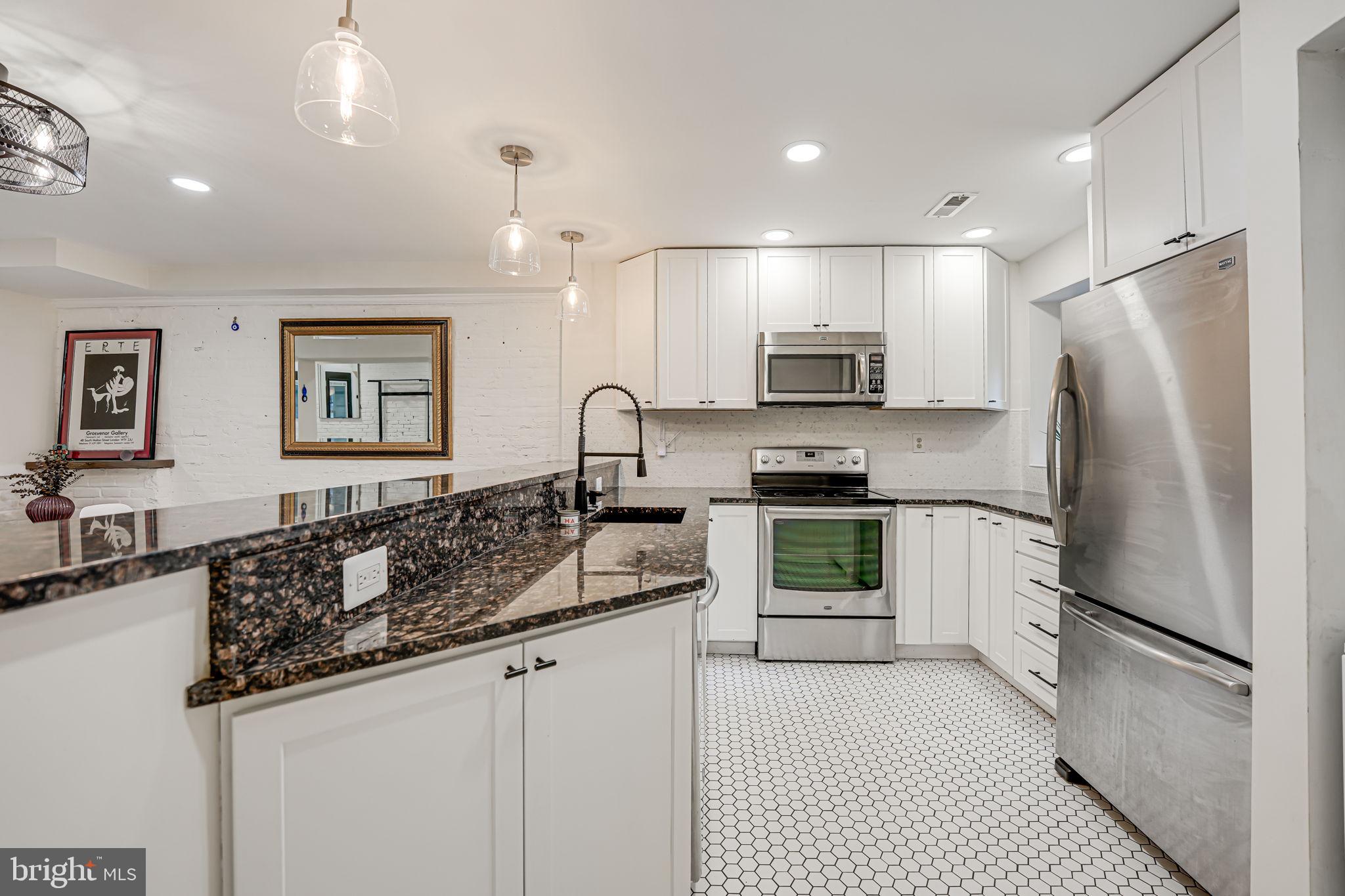 1326 R Street Northwest, Unit 1 Washington, DC 20009 - Photo 12 of 32 a kitchen with stainless steel appliances granite countertop a refrigerator a stove a sink and a oven