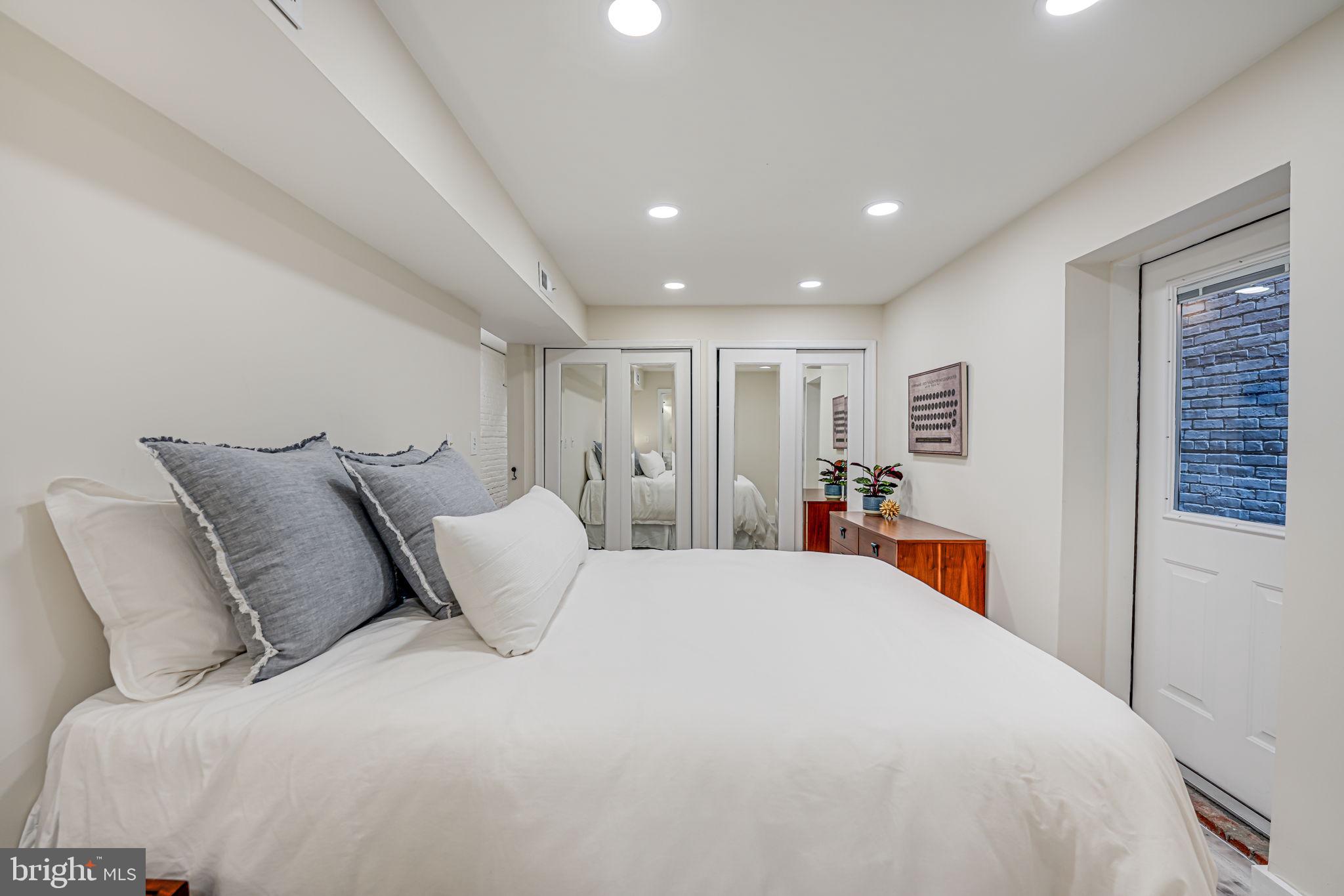 1326 R Street Northwest, Unit 1 Washington, DC 20009 - Photo 21 of 32 a large bed sitting in a bedroom and a table