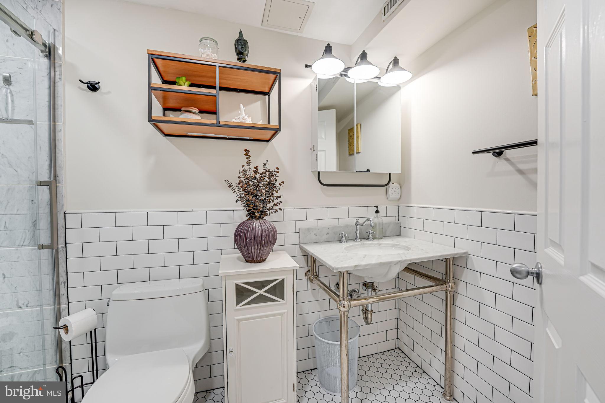 1326 R Street Northwest, Unit 1 Washington, DC 20009 - Photo 22 of 32 a bathroom with a sink mirror and toilet