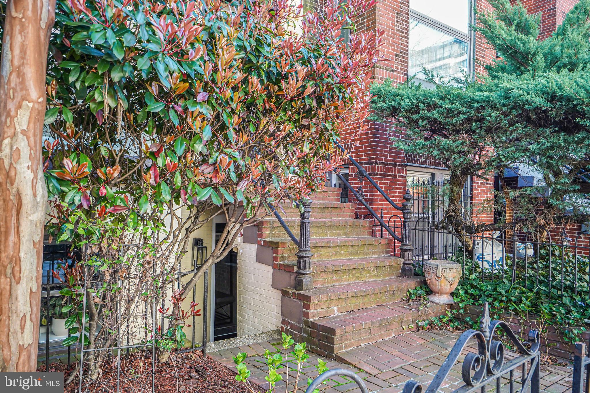 1326 R Street Northwest, Unit 1 Washington, DC 20009 - Photo 30 of 32 a pathway of a house with wooden fence and plants