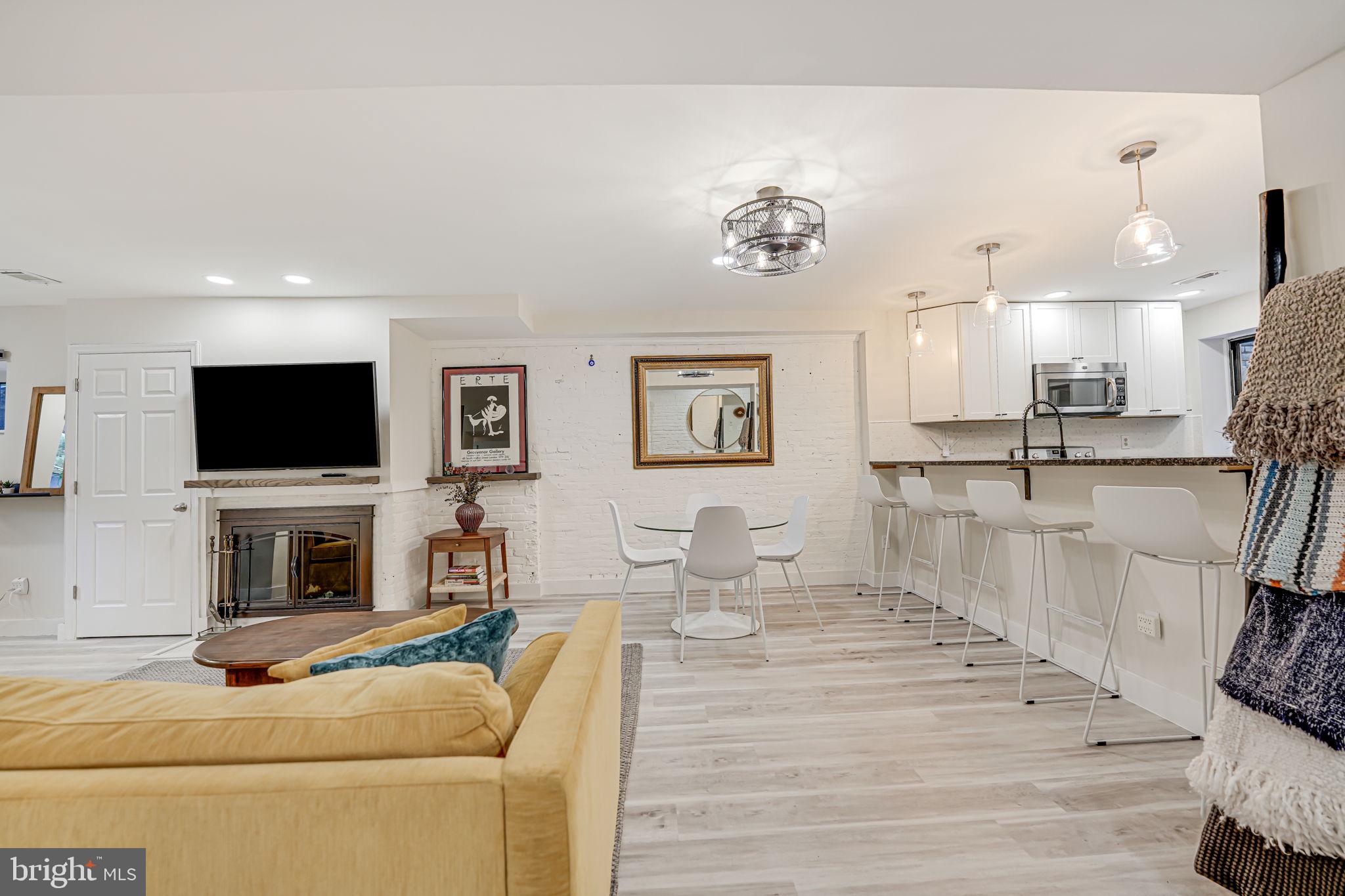 1326 R Street Northwest, Unit 1 Washington, DC 20009 - Photo 3 of 32 a living room with furniture and a flat screen tv