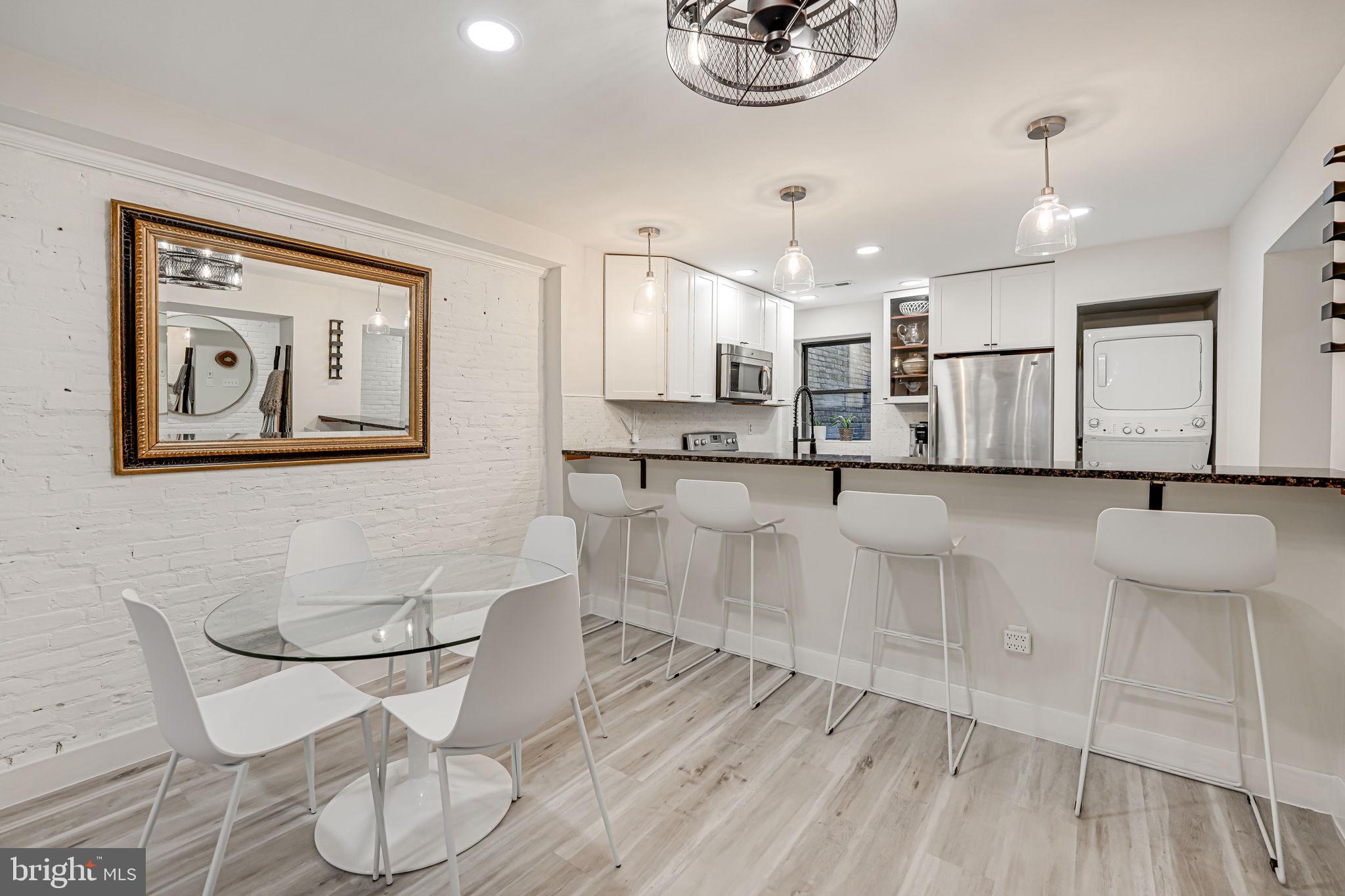 1326 R Street Northwest, Unit 1 Washington, DC 20009 - Photo 10 of 32 a large white kitchen with a large window