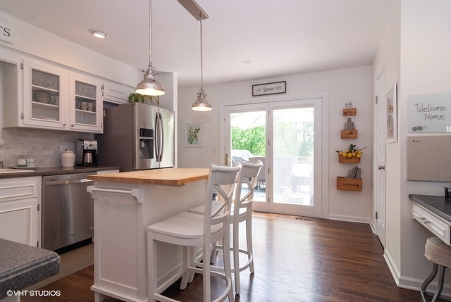 6S235 Cape Road Naperville, IL 60540 - Photo 5 of 19 a kitchen with a table chairs refrigerator and wooden floor