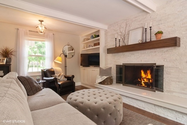 6S235 Cape Road Naperville, IL 60540 - Photo 8 of 19 a living room with furniture a fireplace and a flat screen tv