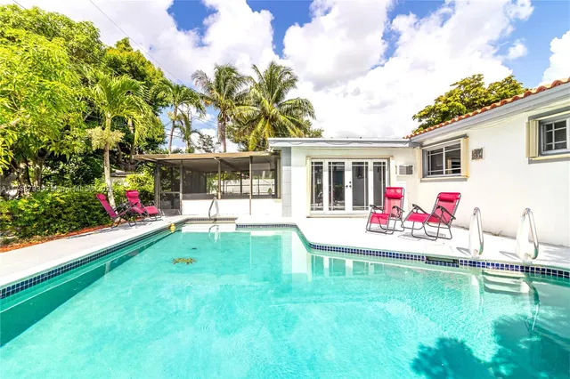 a view of a house with a backyard and a patio