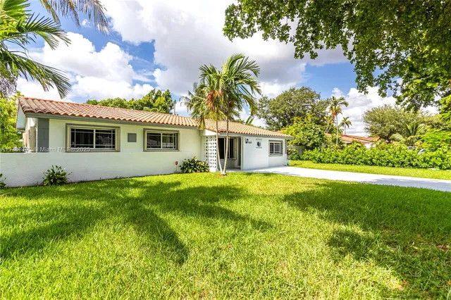 a front view of house with yard and green space
