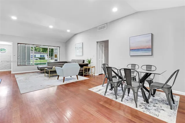 a view of a dining room with furniture and wooden floor