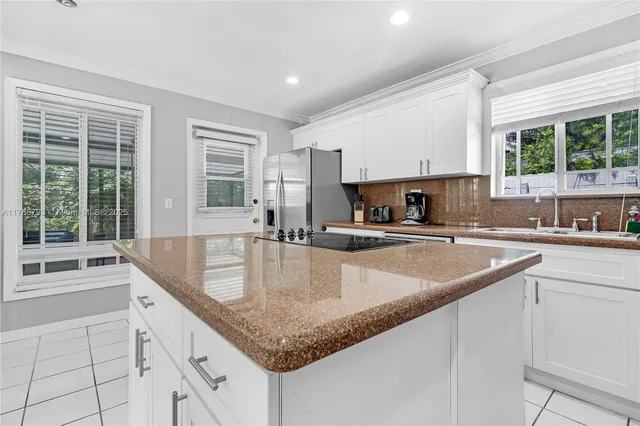 a kitchen with granite countertop a sink and a counter top space