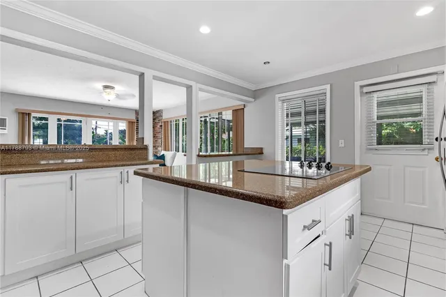 a kitchen with granite countertop a sink and cabinets