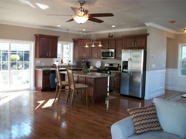 72 Mountford Road Hull, MA 02045 - Photo 5 of 30 a kitchen with stainless steel appliances kitchen island granite countertop a refrigerator a stove a microwave oven a dining table and chairs with wooden floor