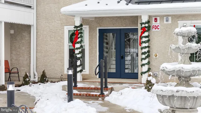 a view of a bedroom with wooden floor and window