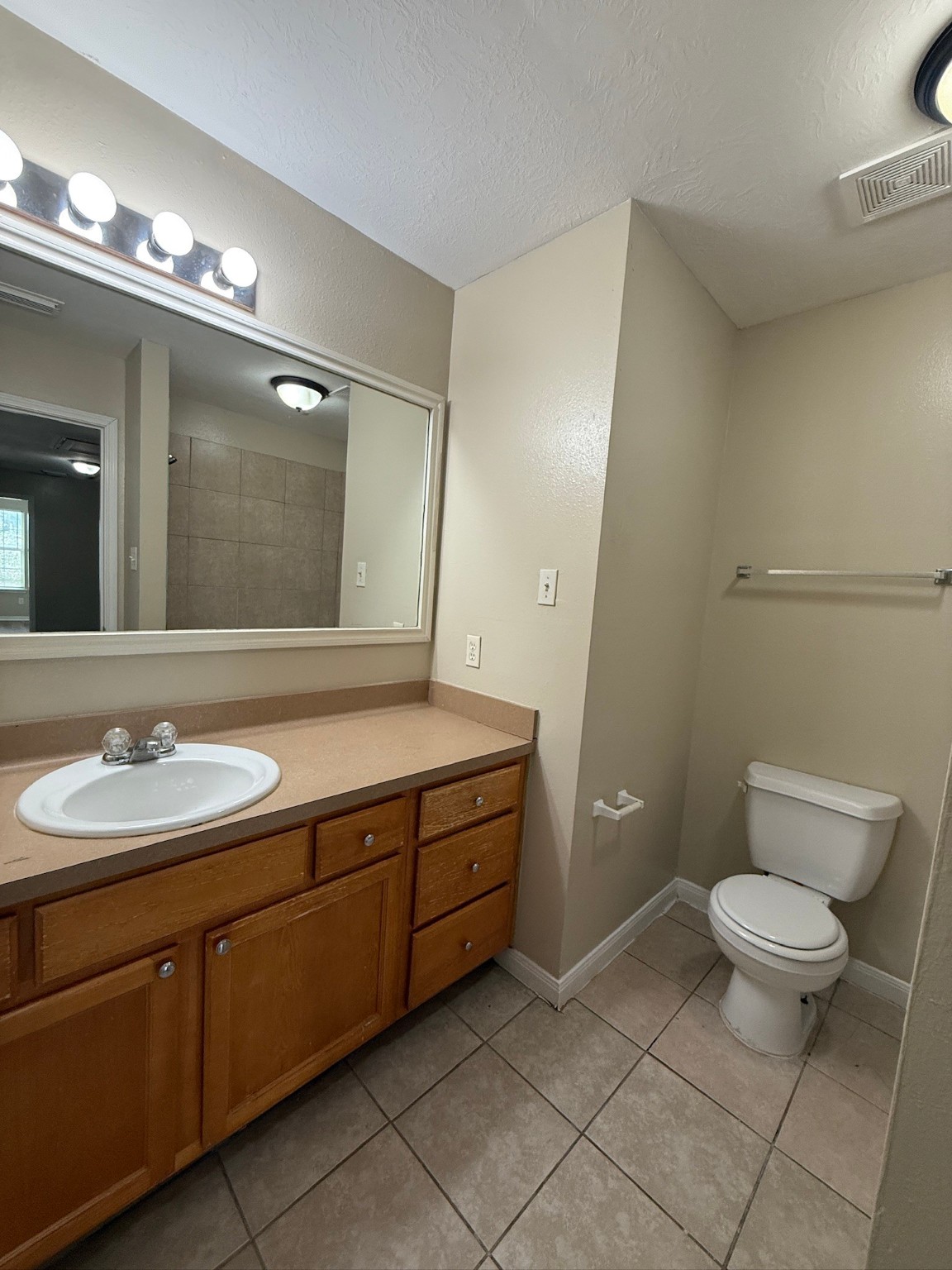 5907 Allison Road Houston, TX 77048 - Photo 10 of 11 a bathroom with a toilet sink and mirror