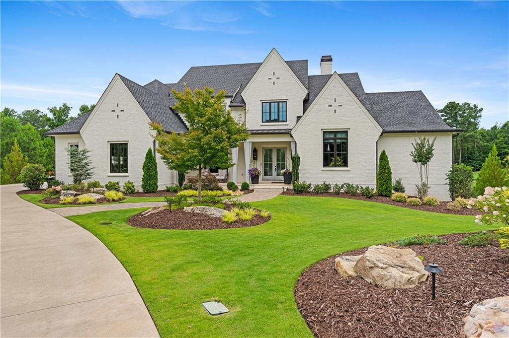 a front view of a house with a yard and garage