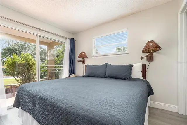 a large bed sitting in a bedroom next to a window