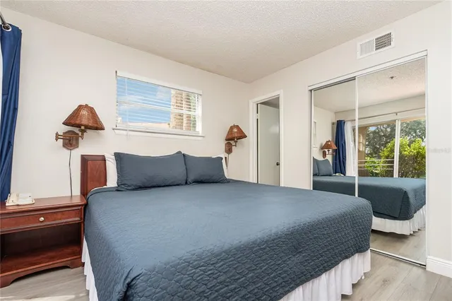 a bedroom with a large bed and a window