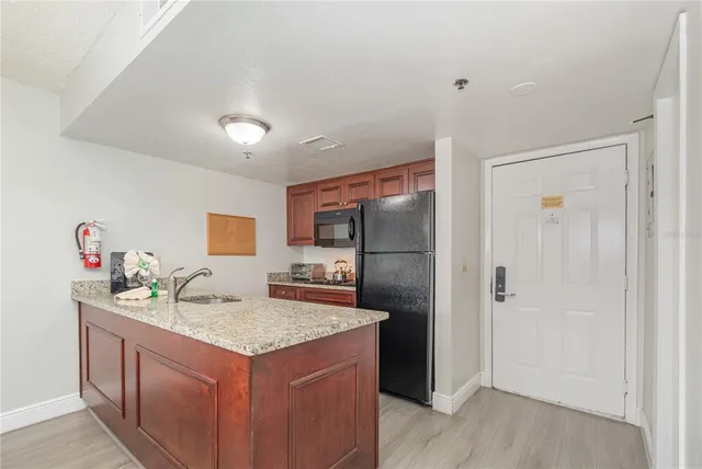 a kitchen with a sink and refrigerator