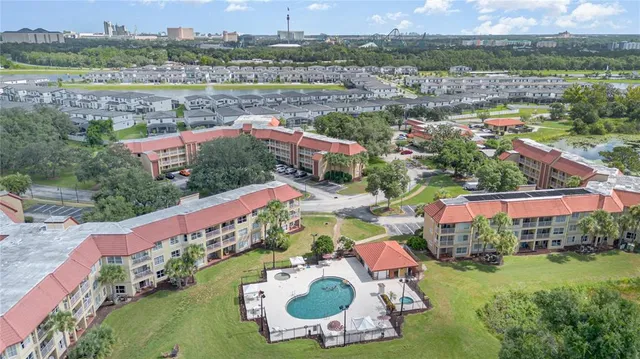an aerial view of a house with yard swimming pool and outdoor seating