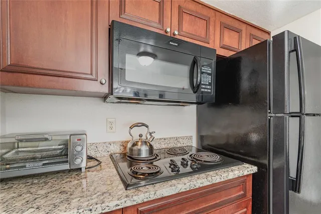 a kitchen with a stove and a refrigerator