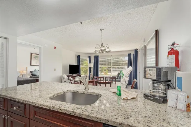 a kitchen with sink refrigerator and large window