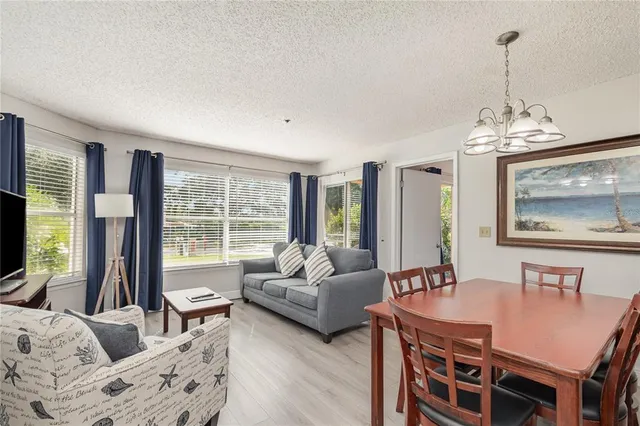 a living room with furniture a flat screen tv and a large window