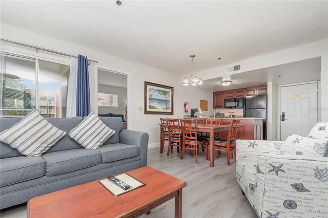 a living room with furniture a rug and a table