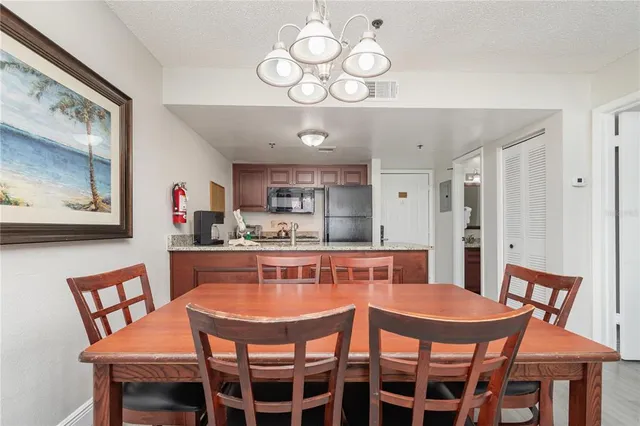 a dining room with a wooden table and chairs