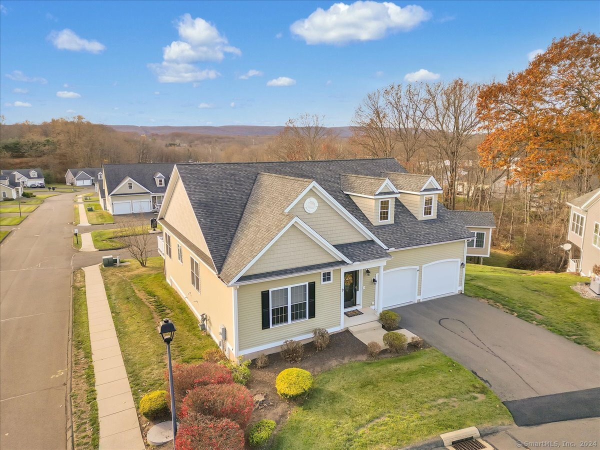 a front view of a house with yard swimming pool and outdoor seating