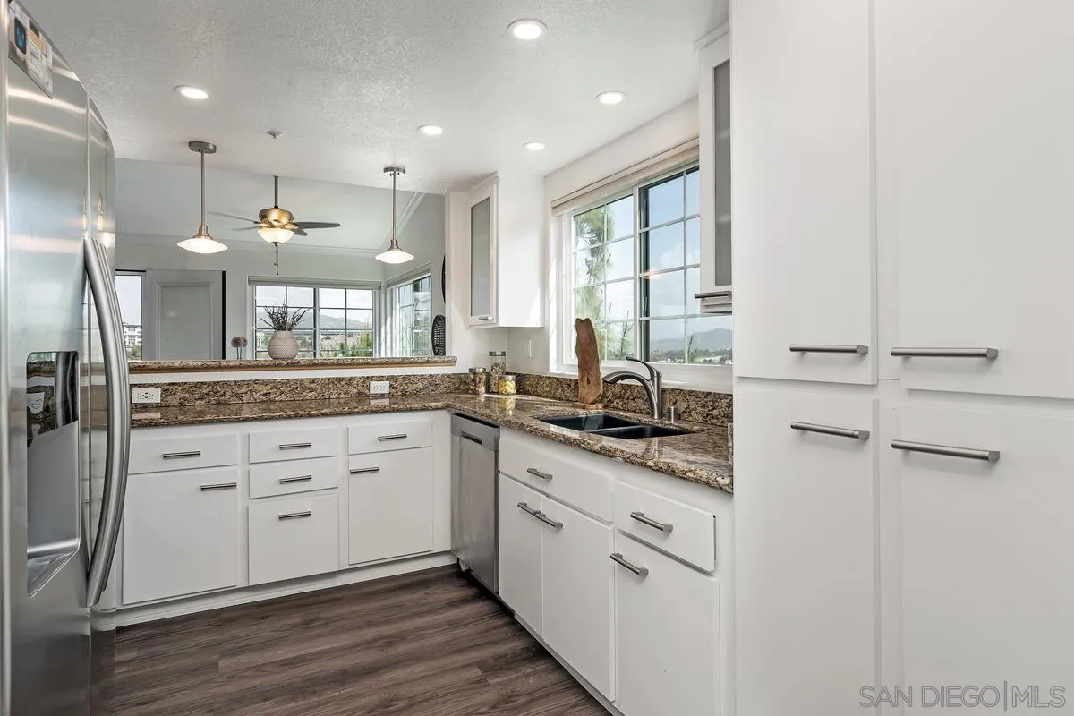 16470 Avenida Venusto, Unit F Rancho Bernardo, CA 92128 - Photo 12 of 30 a large white kitchen with a window and sink