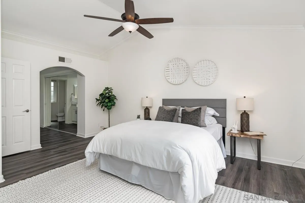 16470 Avenida Venusto, Unit F Rancho Bernardo, CA 92128 - Photo 19 of 30 a spacious bedroom with a bed and wooden floor