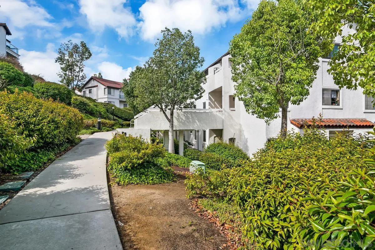 16470 Avenida Venusto, Unit F Rancho Bernardo, CA 92128 - Photo 2 of 30 front view of a house with a yard