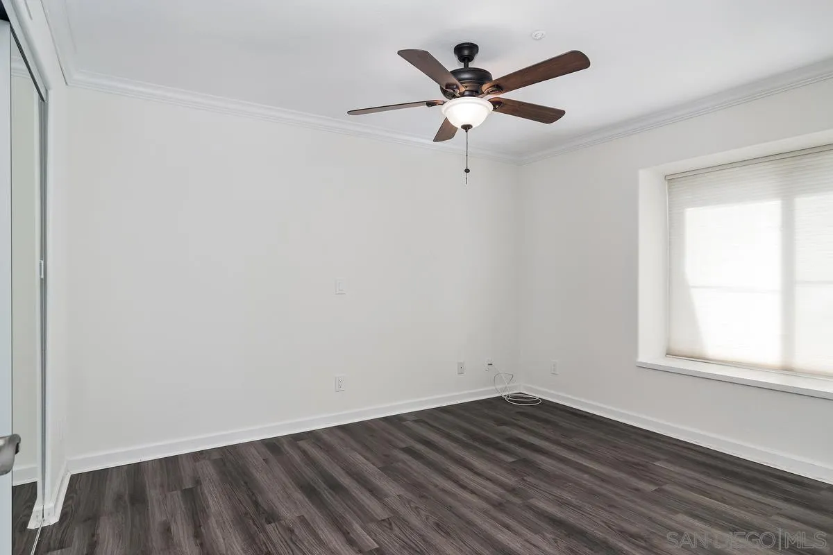 16470 Avenida Venusto, Unit F Rancho Bernardo, CA 92128 - Photo 24 of 30 an empty room with wooden floor and windows